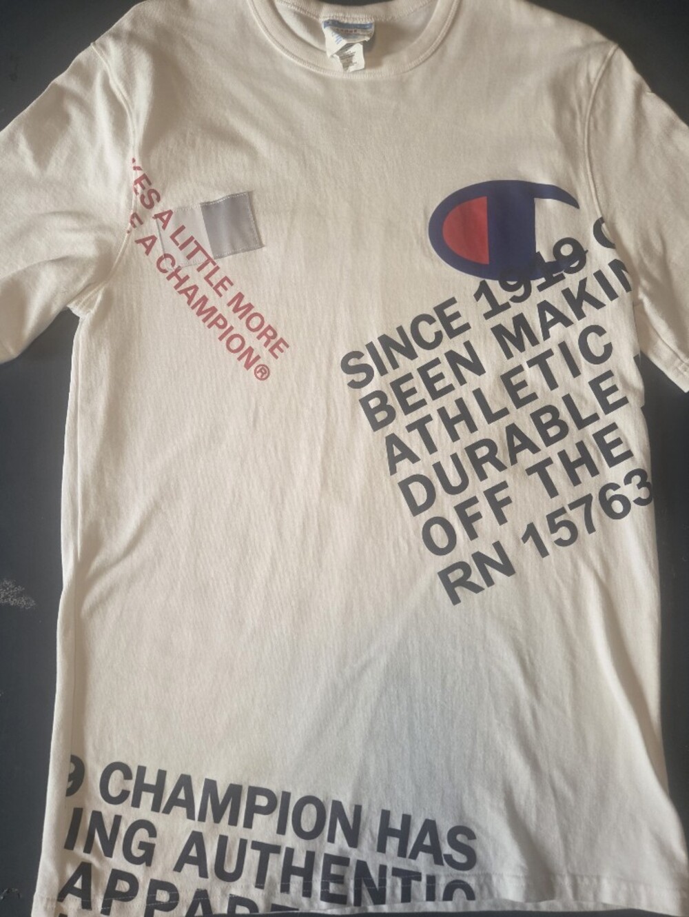 Champion Graphic Logo Tee in Off-White with Navy & Red Print